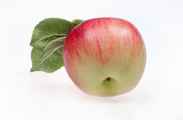 Ripe red and yellow apple with leaves on a white background