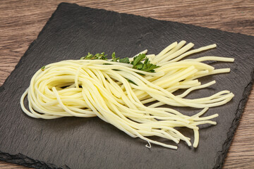 Chechil spaghetti cheese over board