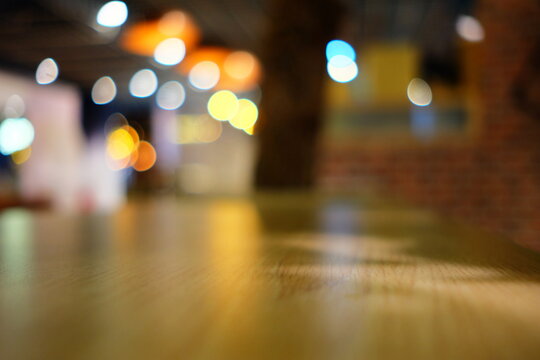 Beautiful Surface of Wooden Table in Cafe with Bokeh Background. (Selective Focus)