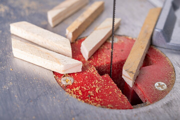 Cutting wood with a table jigsaw. Cutting complex shapes in a wooden board.