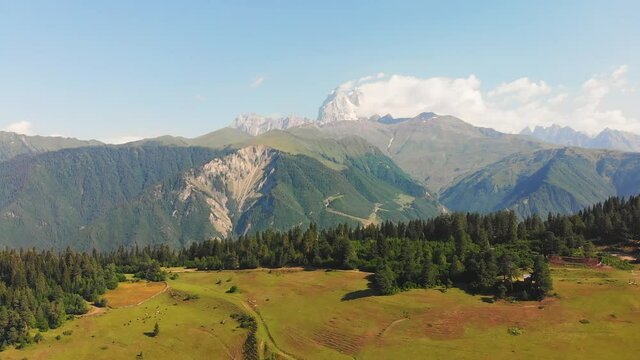Aerial view of caucasus mountains landscape with Ushba summit peak in background
