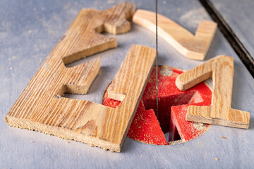 Cutting wood with a table jigsaw. Cutting complex shapes in a wooden board.
