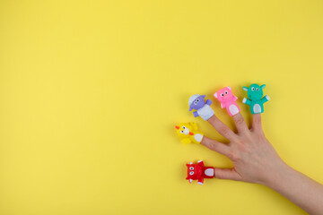 Female hand with 5 finger dolls: cow, sheep, chicken, pig. The concept of child development. Place...