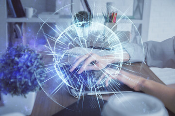 Double exposure of woman hands typing on computer and business theme hologram drawing. Success concept.