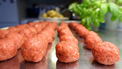 Homemade meatballs on the kitchen counter ready to be cooked