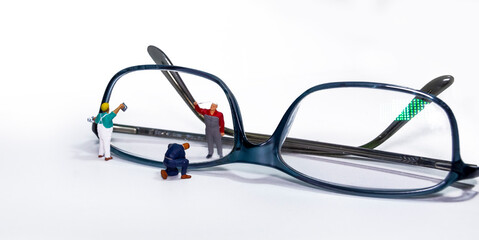 Maintenance workers on a spectacle frame with yellow glasses.