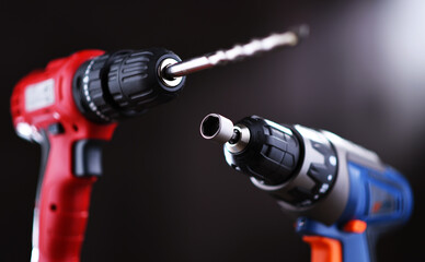 A pistol-grip cordless drill and a screw gun