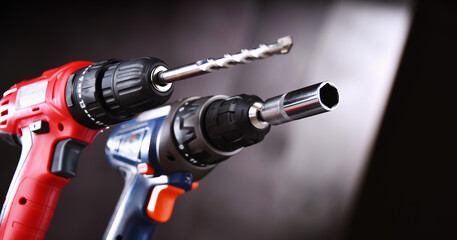 A pistol-grip cordless drill and a screw gun