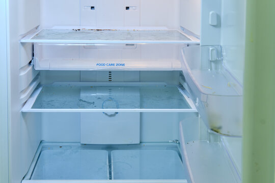 Dirty Fridge With Open Door In Need Of Washing And Cleaning