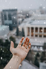 Human hand catching snowflakes.