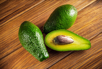 Avocado on vintage wooden table. Raw fruits healthy green food. Avocados banner or diet concept