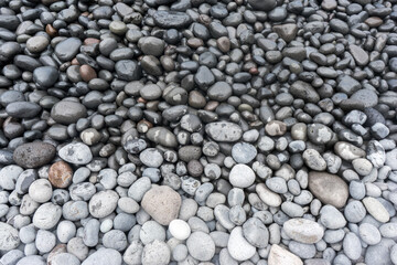 Fototapeta na wymiar Stone beach, half wet, half dry