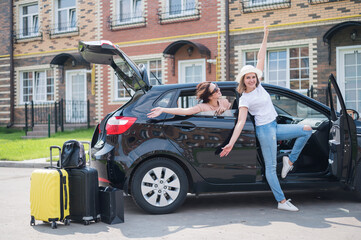 Naklejka na ściany i meble Two young Caucasian women are traveling in a rented car