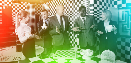 Portrait of laughing people in business suits spending time in quest room