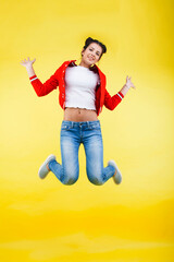 young pretty brunette girl jumping isolated on yellow background, lifestyle flying teen people concept