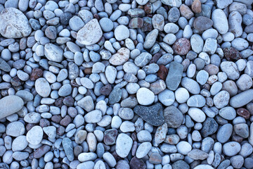 Grey pebbles and stones on the beach, top view