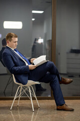 Workplace attorney success collar executive notary broker lawyer people corporate concept. Concentrated serious handsome pensive smart clever broker realtor recruiter using netbook at work