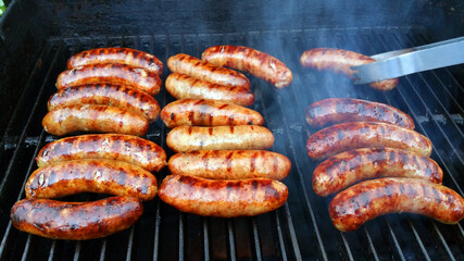 Fototapeta Sausages Or Brats Cooking On A Grill obraz