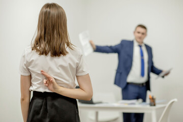 Obraz premium Angry boss yelling at his young employee, she is stressed and feeling frustrated: hostile boss and mobbing concept