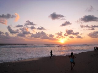 People walking on Nusa Dua Beach at dusk, Beautiful sunset, Bali island, Indonesia