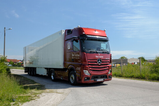 New Mercedes Actros truck in beautiful red colour. Mercedes Actros with trailer in motion.
