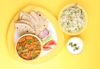 mix veg curry made from carrot, beans, and green peas served with roti, green peas pulao and curd