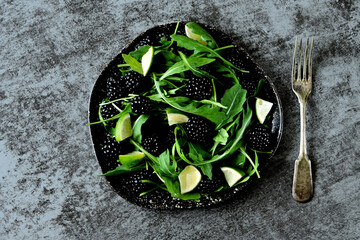 Healthy fresh salad with arugula and blackberries.
Vegan lunch.