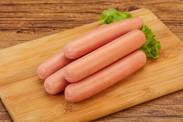 Tasty meat sausages over board