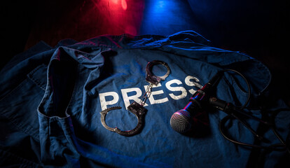 Freedom of the press and journalism concept. Blue journalist (press) vest in dark with backlight...