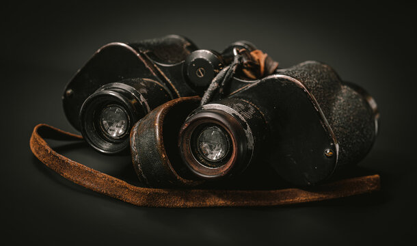 vintage WWII era binocular on black background