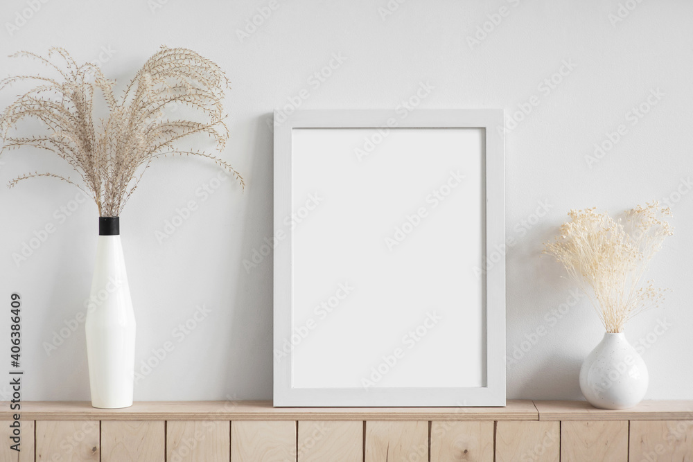 Wall mural blank picture frame mockup on white wall. white living room design. view of modern scandinavian styl