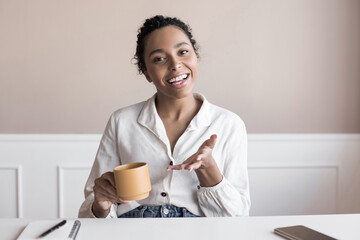 Beautiful business woman looking and speaking through the web camera while making a video...