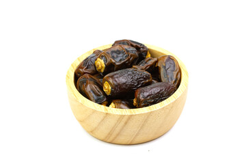Close-up dried dates palm in wooden bowl isolated on white background.