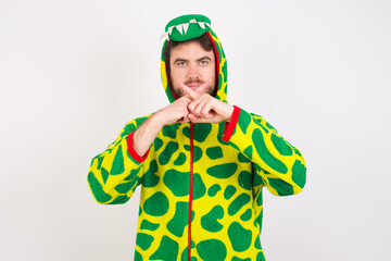 Young caucasian man wearing a pajama standing against white background Has rejection angry expression crossing fingers doing negative sign.