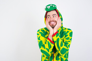 Fototapeta premium Inspired Young caucasian man wearing a pajama standing against white background looking at copyspace having thoughts about future events