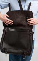 Details of open brown men's shoulder leather bag for a documents and laptop on the shoulders of a...