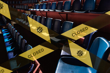 prohibitive tape on the background of a empty plastic seats in a sports stadium arena in the dark. the stadium is closed for quarantine.