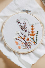 close-up image of embroidery in hoops, delicate beautiful flowers