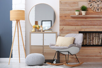 Elegant round mirror in stylish living room interior