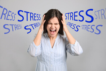 Stressed young woman and text on light grey background