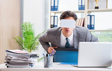 Businessman with VR virtual reality glasses in office