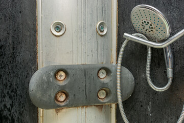 close-up of the shower head and shower stall are very dirty, disgusting, covered with old dirt,...