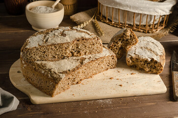 Cut freshly baked whole grain rye bread, homemade baked goods.