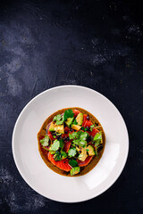 Top view of seared salmon with avocado in bowl, seared salmon salad with sauce at a premium restaurant