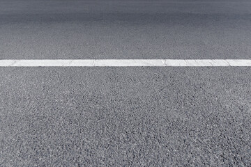 Fototapeta premium A paved street road with white traffic lines is an empty background. Concept highway city road and country road.