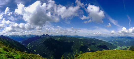 Naklejka na ściany i meble wonderful mountain landscape with clouds on the blue sky panorama