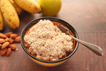 Close up of oats flakes in a bowl on table 