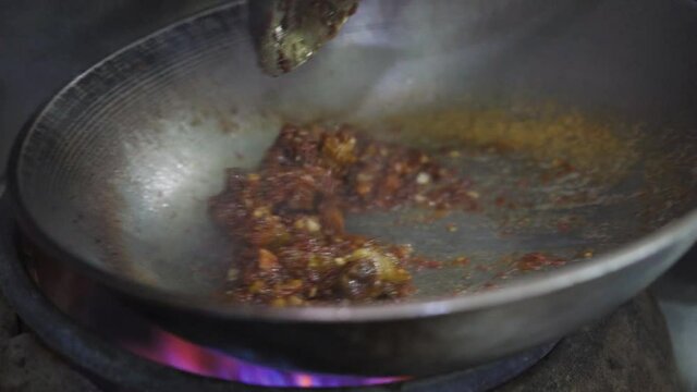 Stir-Frying Pork Belly In Shrimp Paste Sauce Over High Heat In A Wok. - close up