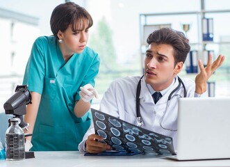 Two doctors discussing x-ray MRI image in hospital