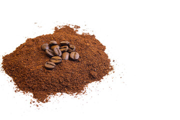 Roasted coffee beans at the top of a pile of ground coffee on an isolated white background. With white area for copy space text.